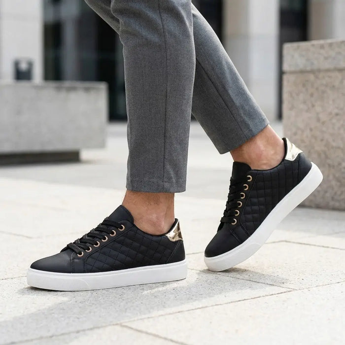 Women's quilted lace-up sneakers in white with low-top design and casual style, featuring smooth quilted material and comfortable fit.