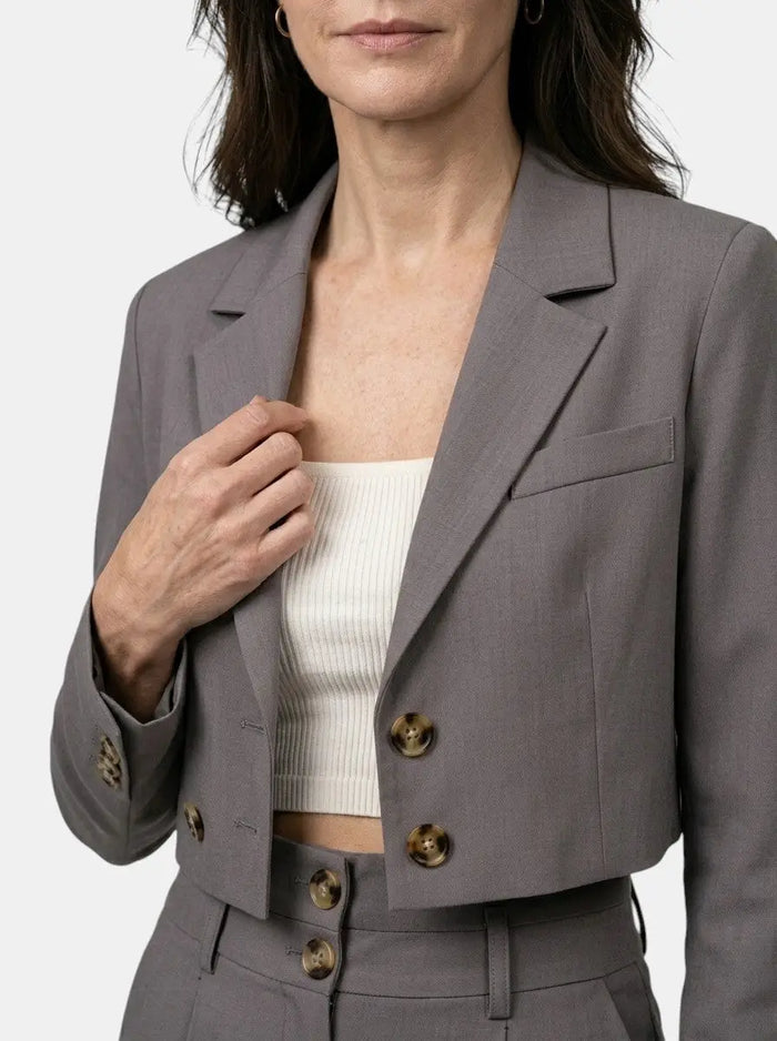 Women's structured pant suit featuring a tailored cropped blazer and high-waist wide-leg trousers, stylish and professional.