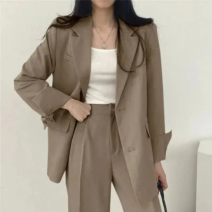 Women's tailored blazer suit set featuring an elegant structured blazer and wide-leg trousers, perfect for professional or chic occasions.