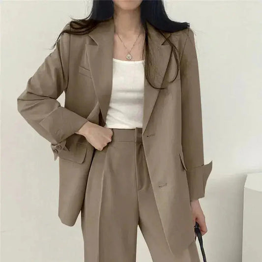 Women's tailored blazer suit set featuring an elegant structured blazer and wide-leg trousers, perfect for professional or chic occasions.