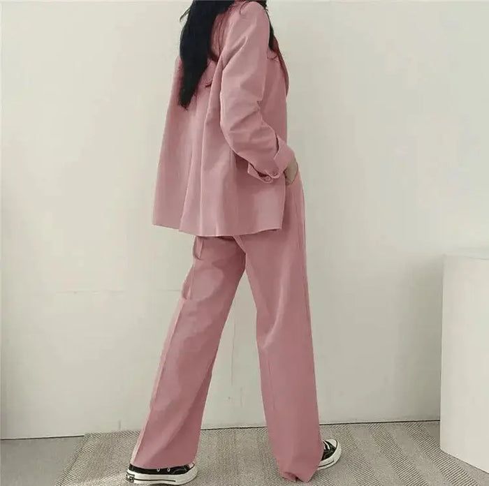 Women's tailored blazer suit set featuring an elegant structured blazer and wide-leg trousers, perfect for professional or formal wear.