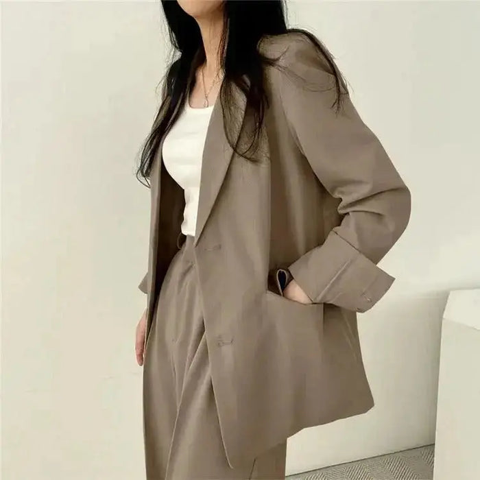 Women's tailored blazer suit set featuring an elegant structured blazer and wide-leg trousers, perfect for professional or formal wear.