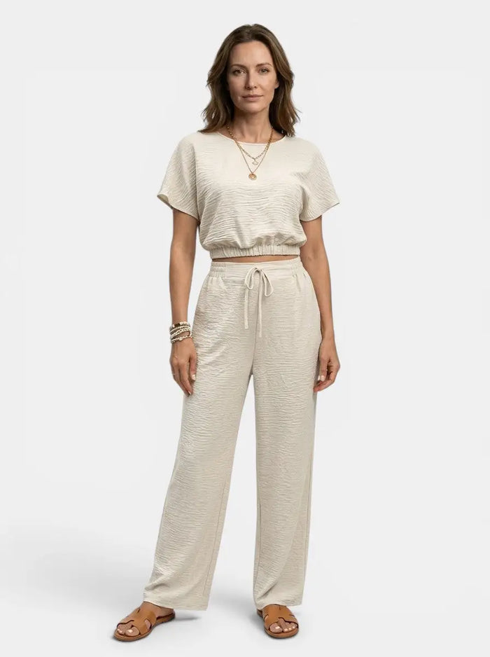 Women's textured cotton loungewear set with a relaxed crop top and wide-leg trousers, perfect for comfortable casual wear.