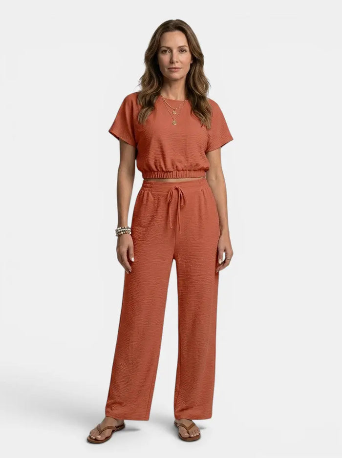 Women's textured cotton loungewear set featuring a relaxed crop top and wide-leg trousers, perfect for comfortable casual wear.