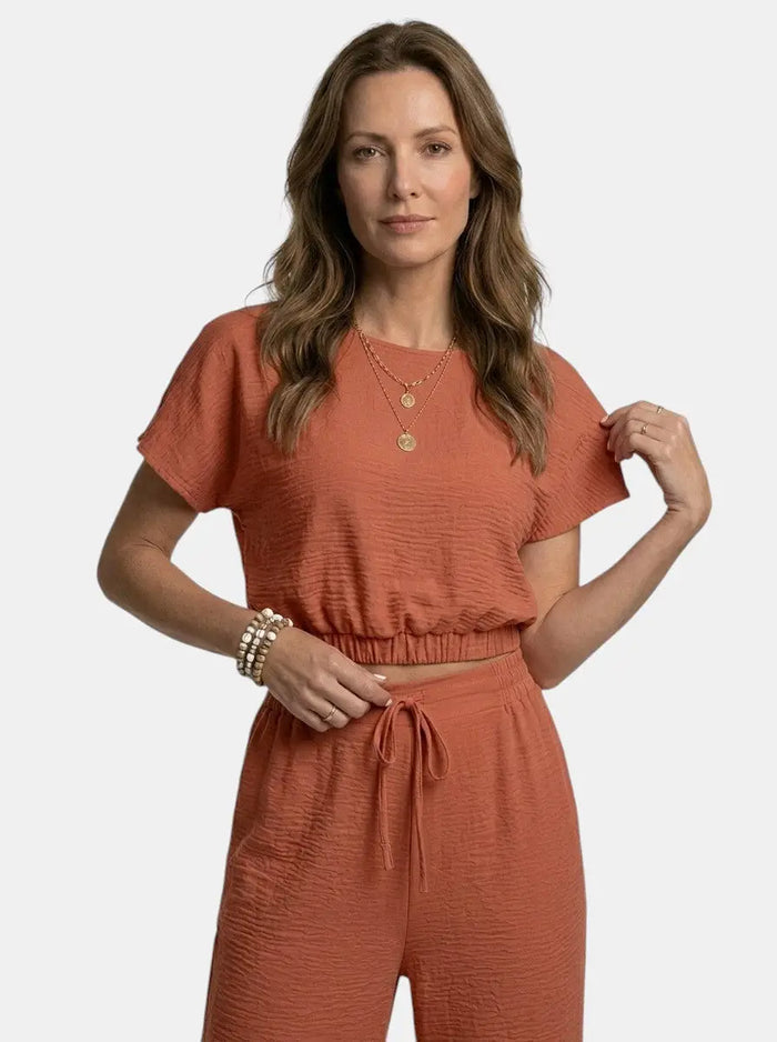Women's textured cotton loungewear set with relaxed crop top and wide-leg trousers, stylish and comfortable for casual wear.