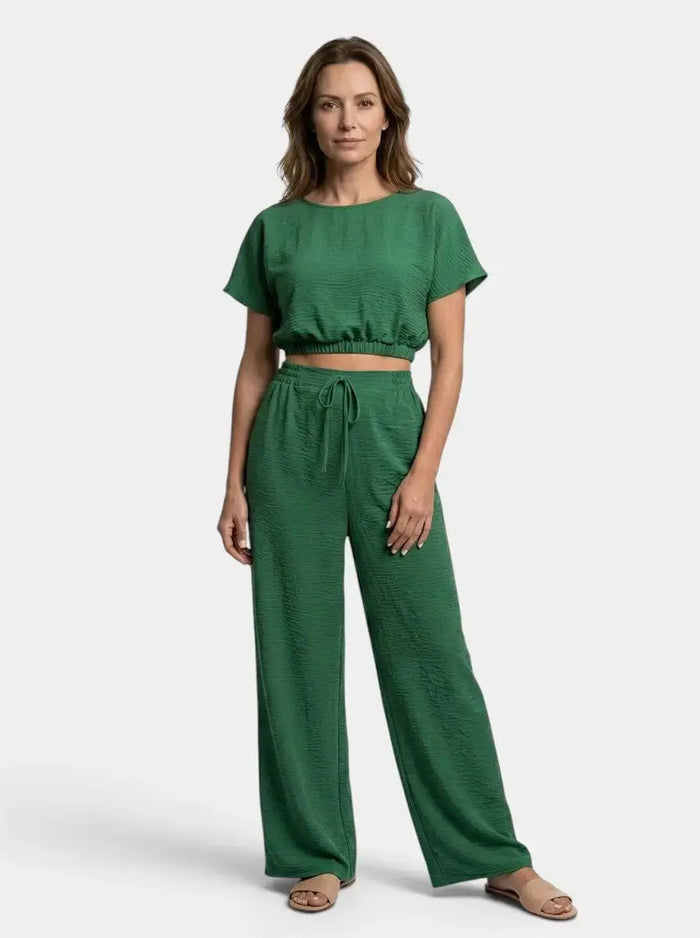 Women's textured cotton loungewear set with relaxed crop top and wide-leg trousers, stylish and comfortable for casual wear.