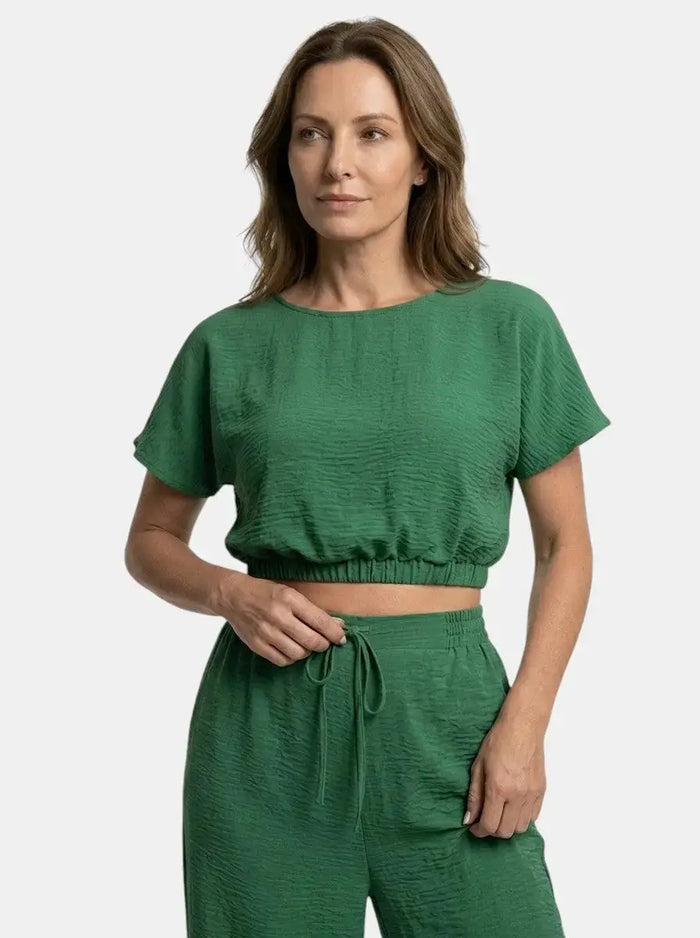 Women's textured cotton loungewear set with relaxed crop top and wide-leg trousers, featuring soft, comfortable fabric and modern style.