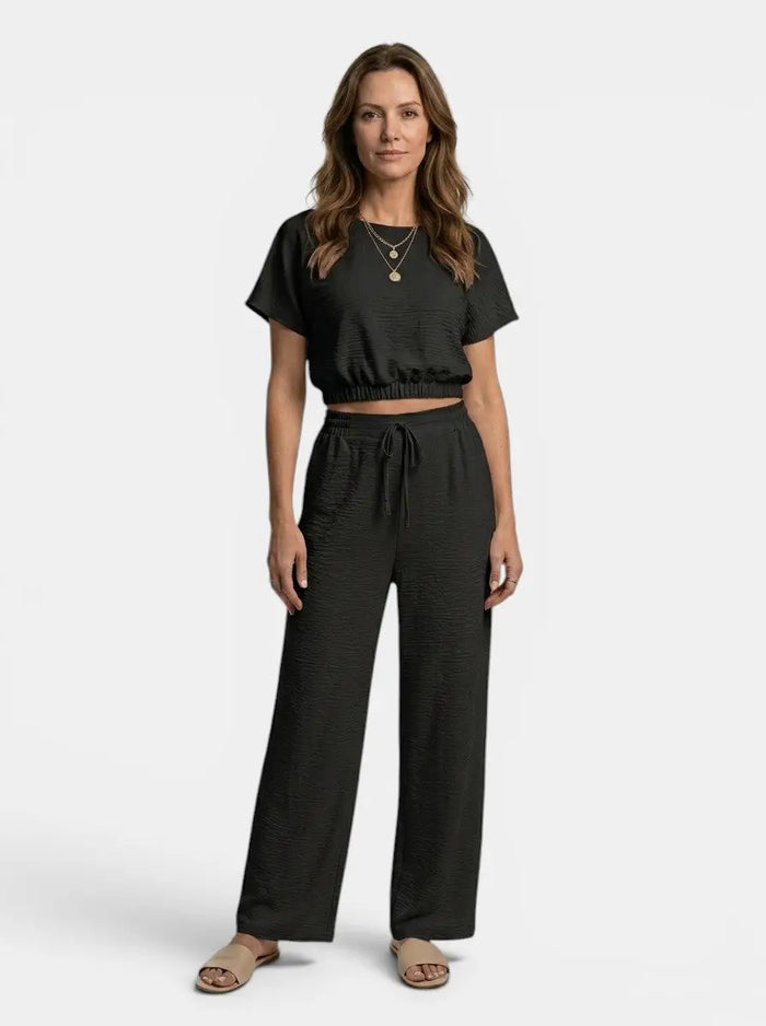 Women's textured cotton loungewear set with relaxed crop top and wide-leg trousers, comfortable and stylish for casual wear.