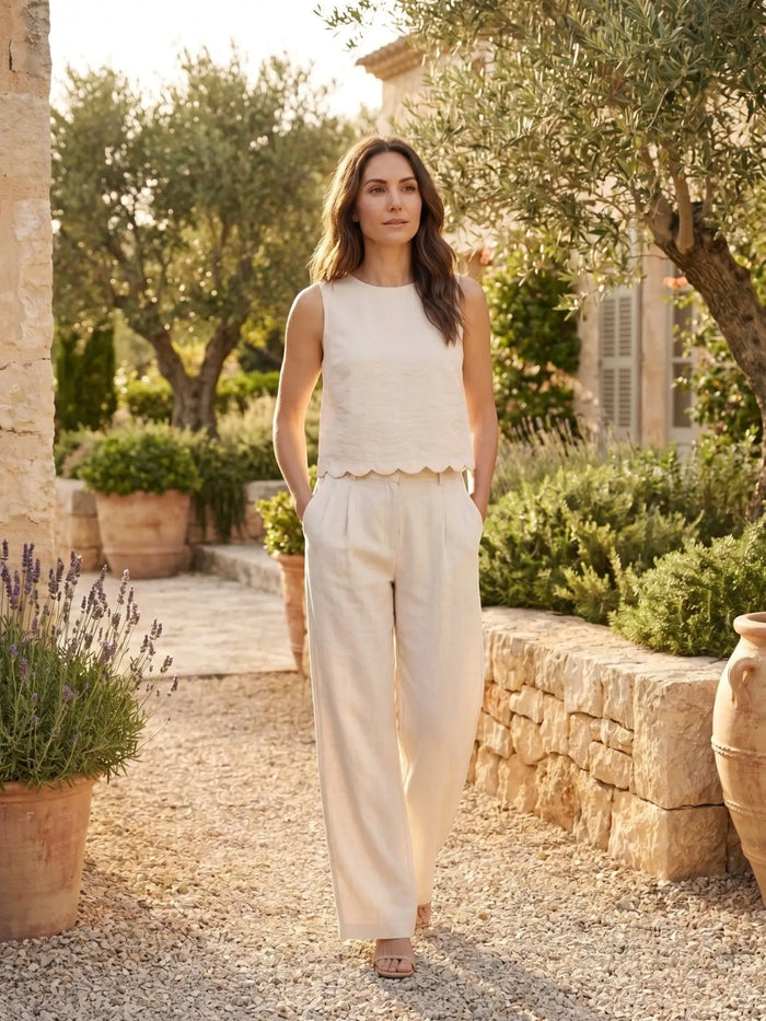 Women's textured fabric wide-leg trouser set with sleeveless scallop hem top, stylish and comfortable for casual or office wear.