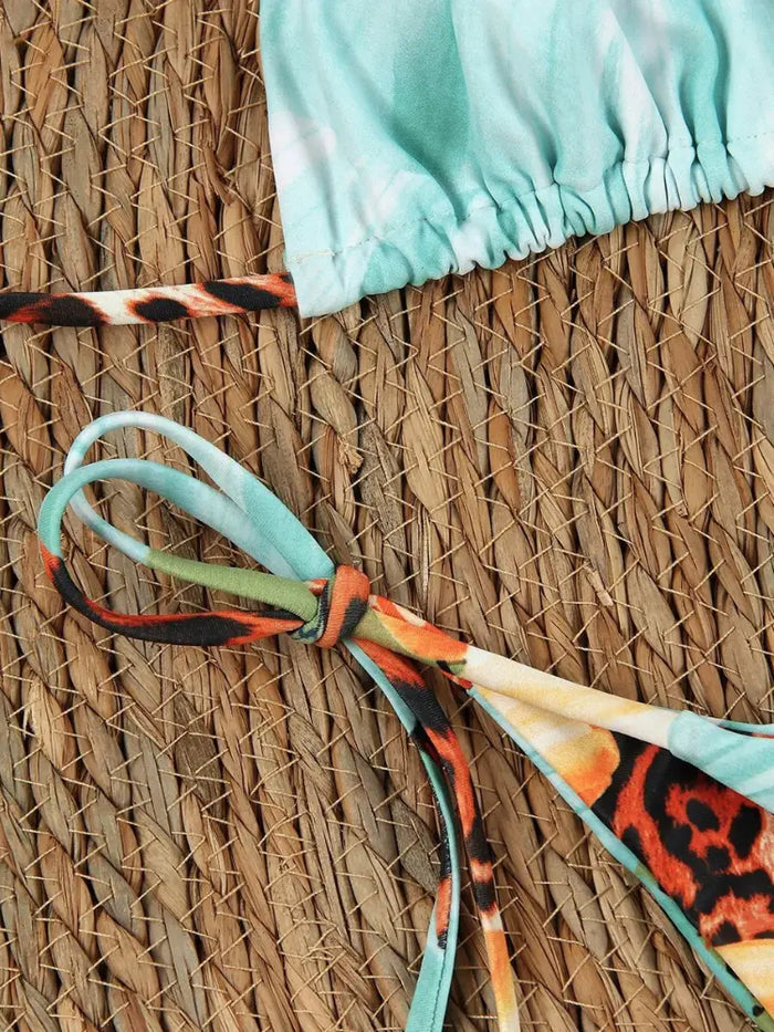 Women wearing a tropical floral 3-piece bikini set by LondonLaneStore, featuring adjustable swimwear and a mesh skirt for stylish beach look.