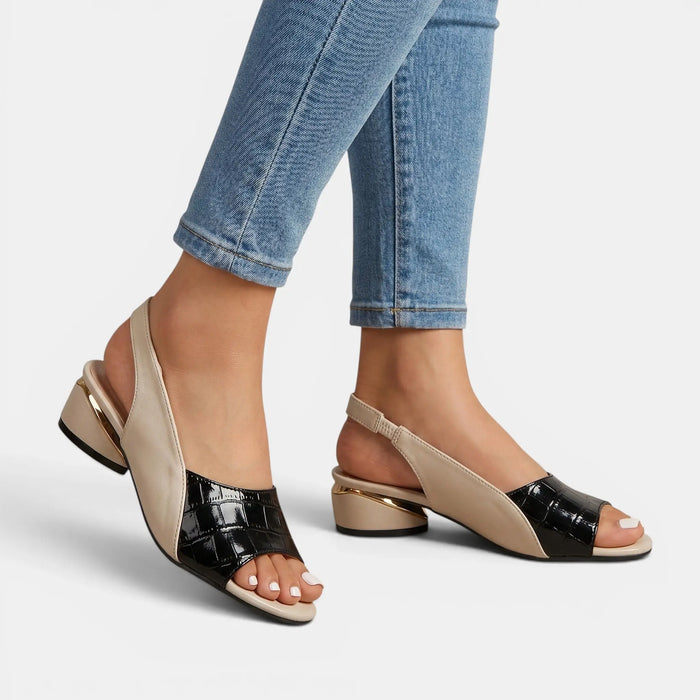Women's two-tone leather sandals with open-toe slingback design, stylish and comfortable for warm weather.