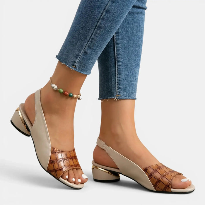 Women's two-tone leather sandals with open-toe slingback design, stylish and comfortable for warm weather.