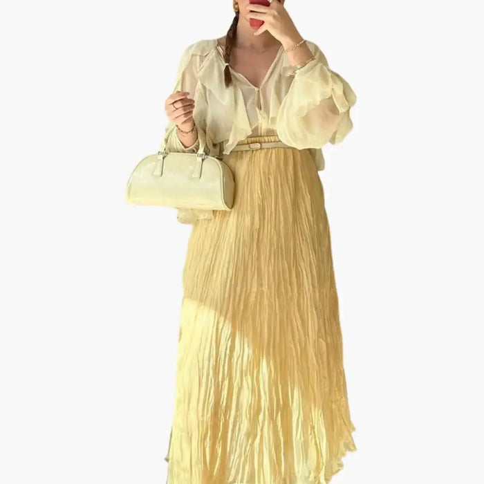 Women’s woven pleated maxi skirt with a structured design and long hemline, featuring elegant details from LondonLaneStore.