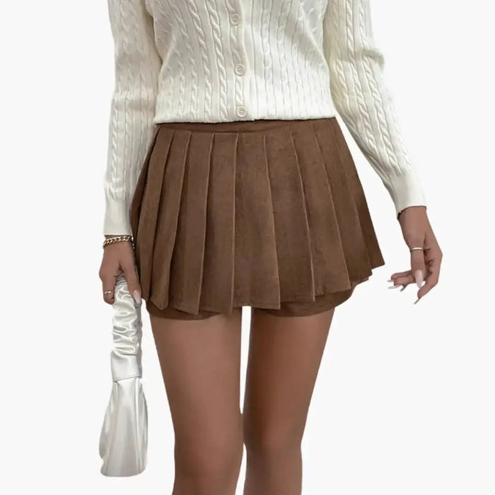 Women’s woven pleated midi skirt with a flowing design and elastic waistband, showcasing its structured and comfortable fit.