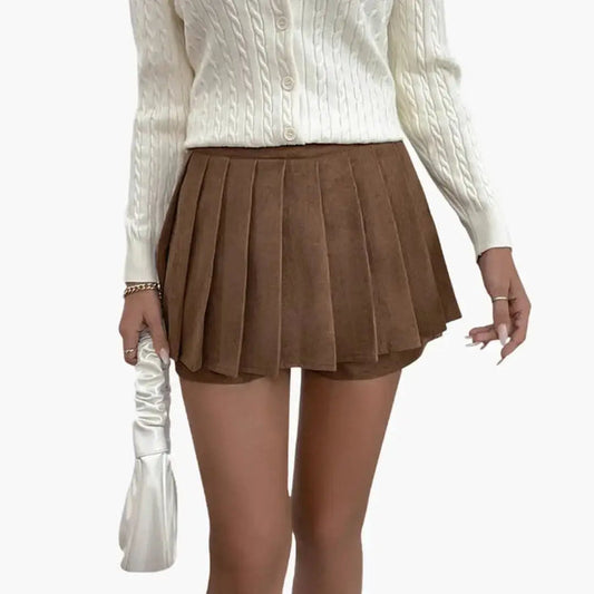 Women’s woven pleated midi skirt with a flowing design and elastic waistband, showcasing its structured and comfortable fit.